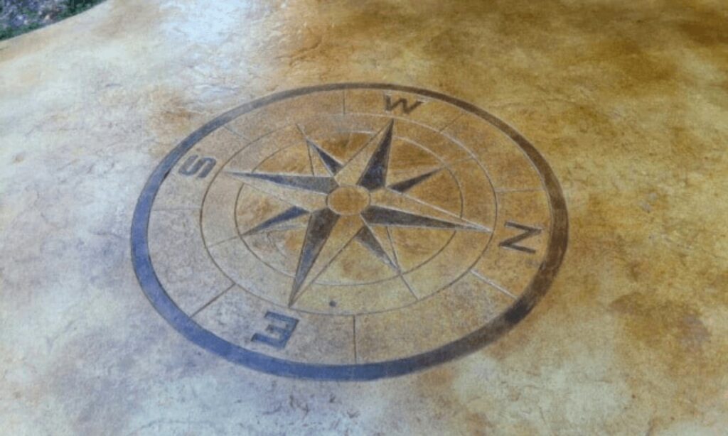 stained concrete patio with compass stamp