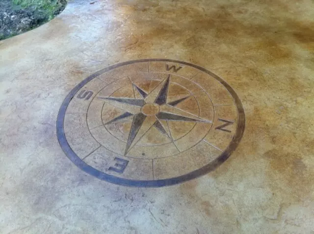 stained concrete patio with compass stamp