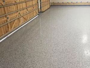 2-car garage with new professional garage floor coating installed by Decorative Concrete of Texas in Celina, Texas.