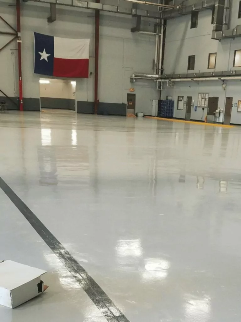 solid color grey epoxy commercial floor coating for American Airlines by Decorative Concrete of Texas